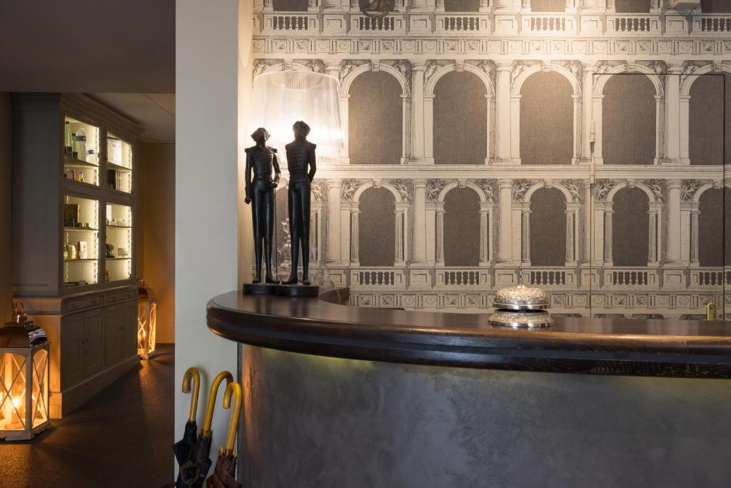 a room with a counter with two statues on it at Hotel Voltaire Opera Nantes Centre in Nantes