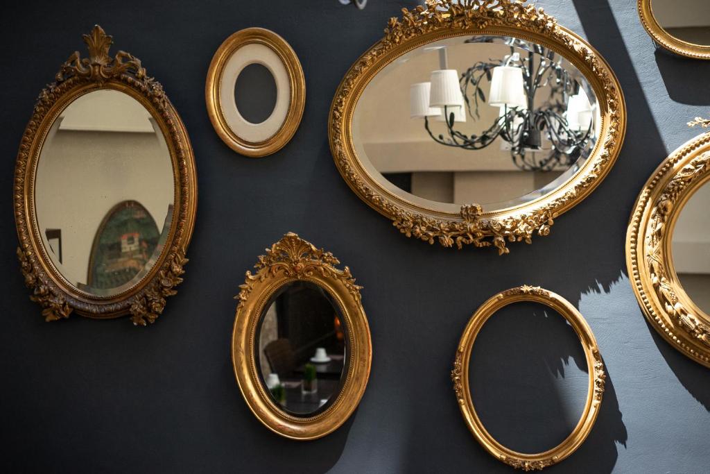 a group of mirrors hanging on a wall at Hotel Voltaire Opera Nantes Centre in Nantes
