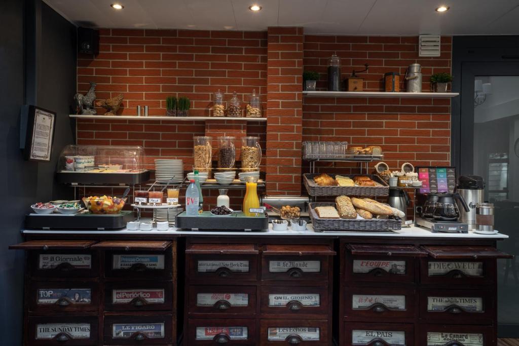 a bakery counter with bread and pastries on display at Hotel Voltaire Opera Nantes Centre in Nantes