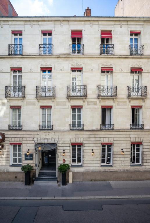 a large white building with windows and balconies at Hotel Voltaire Opera Nantes Centre in Nantes