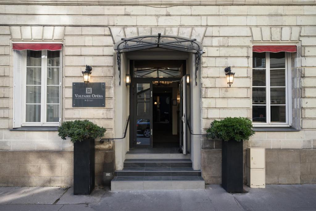 an entrance to a building with a sign on it at Hotel Voltaire Opera Nantes Centre in Nantes