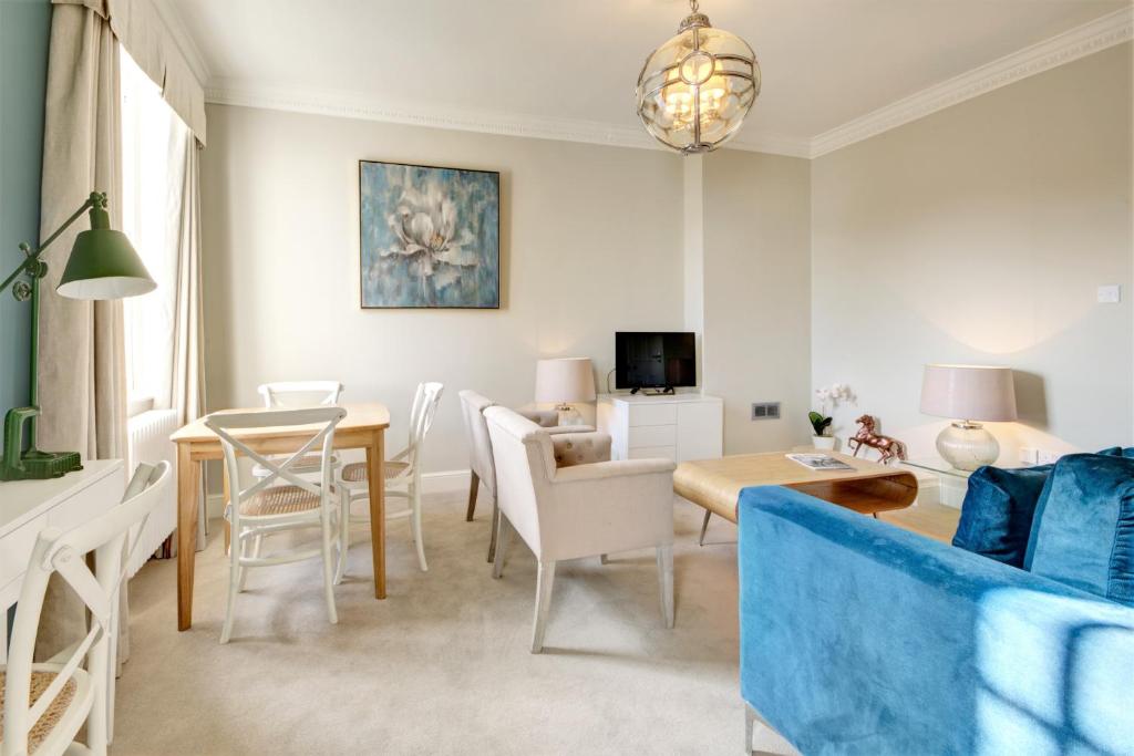 a living room with a couch and a table at Wolcote House in Cheltenham