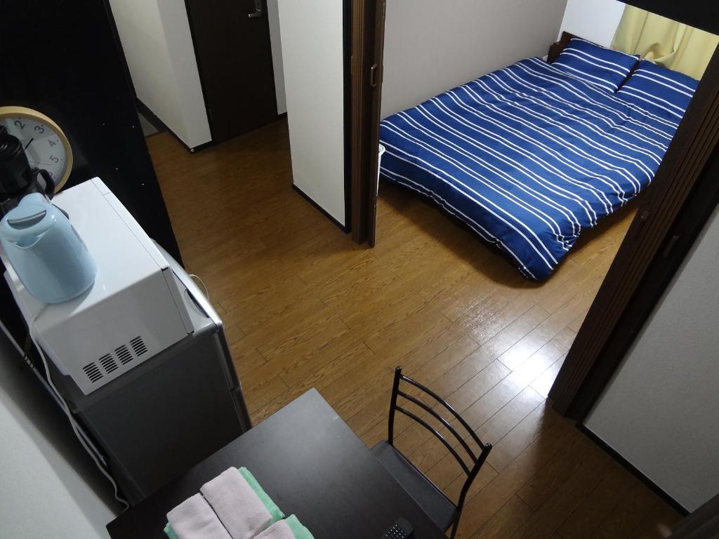 Кровать или кровати в номере Guest House ZEN HAKATA Ohori Park 1
