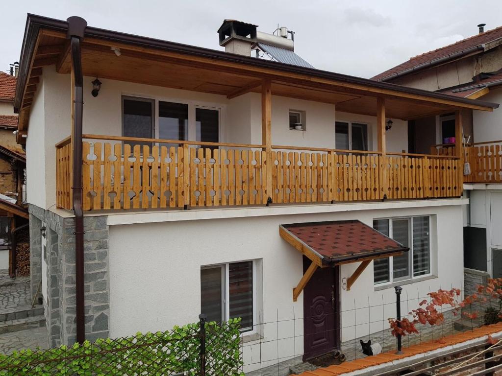 a house with a wooden deck on top of it at Guest house Grahlyov in Sapareva Banya