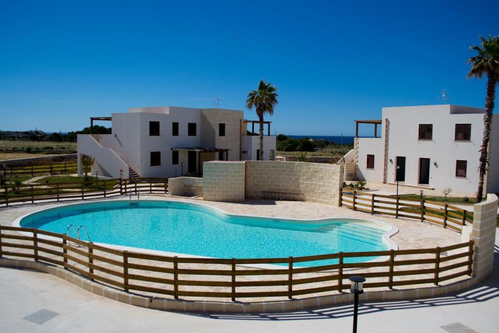 a large swimming pool in front of a house at Boa Vista Favignana - Nuova Gestione 2026 in Favignana