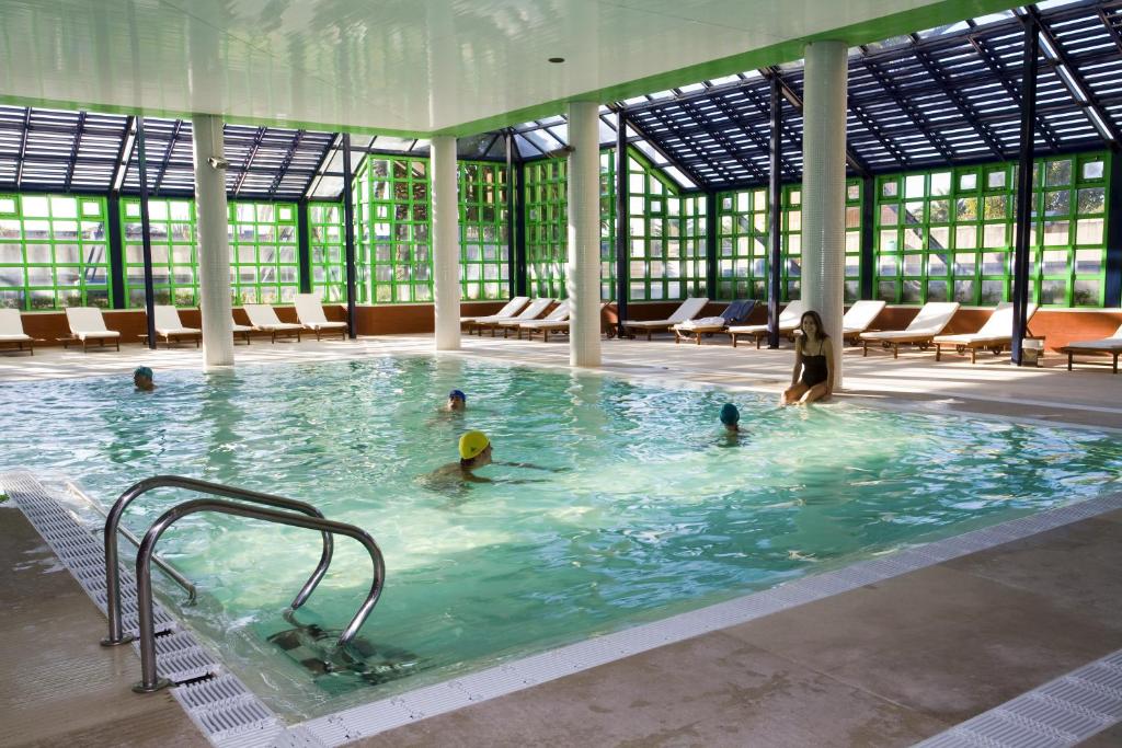 a group of people in a large swimming pool at Hotel Solverde Spa and Wellness Center in Vila Nova de Gaia
