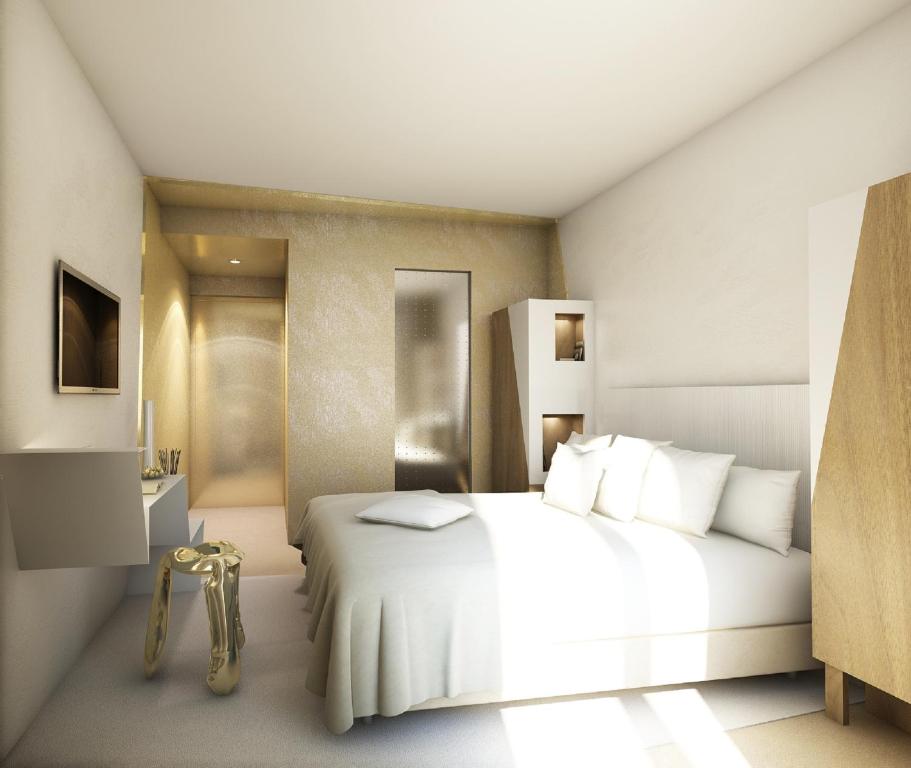 a bedroom with a white bed and a bathroom at Le Malown in Paris