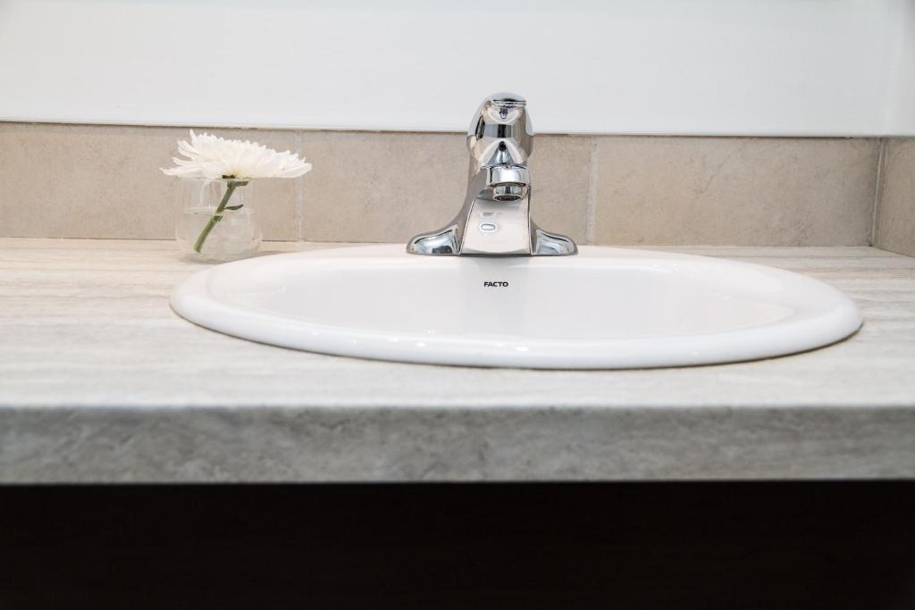 a bathroom sink with a faucet on a counter at Rideau Heights Inn in Ottawa