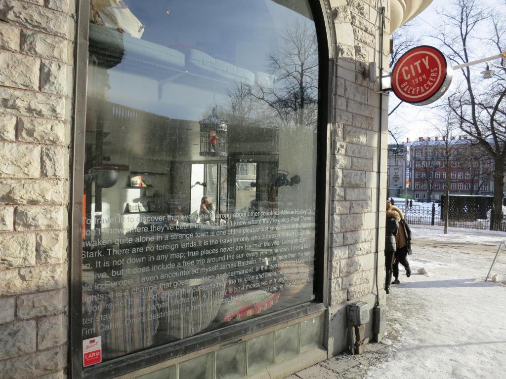 a window of a store with a reflection in it at City Backpackers Hostel in Stockholm
