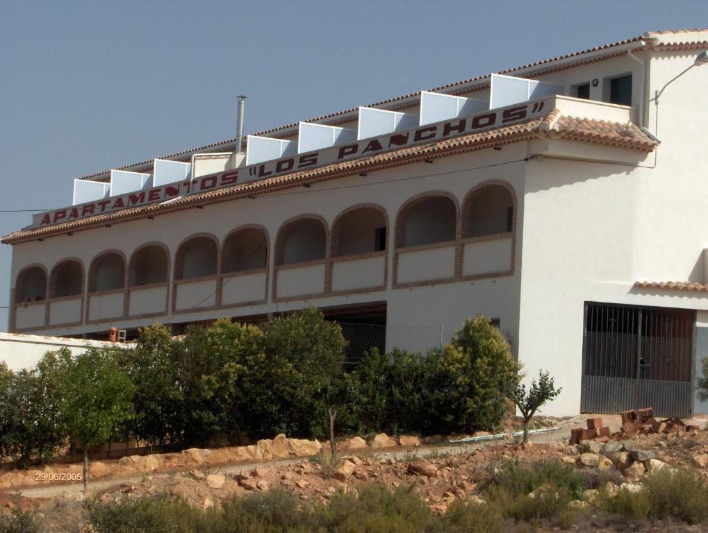 a large white building with the words hotel intolerance on it at Apartamentos Los Panchos in Ruidera