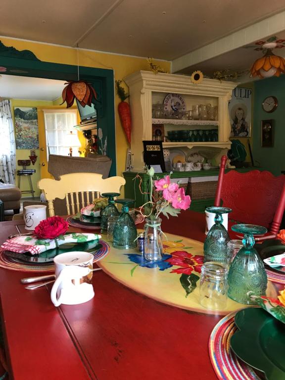 a table with plates and vases on top of it at Klutina Kate's B&B in Copper Center