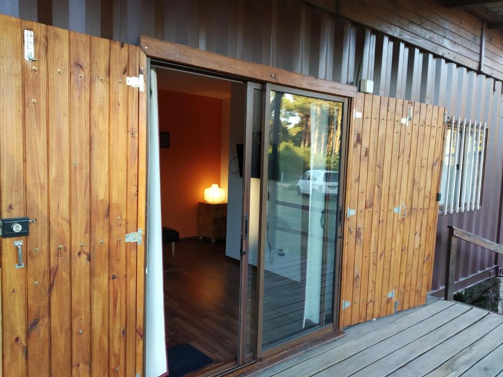 an open sliding glass door on a deck at Sonidos del Mar in Punta Del Diablo