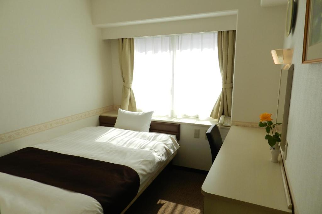 Кровать или кровати в номере Hotel Sambancho