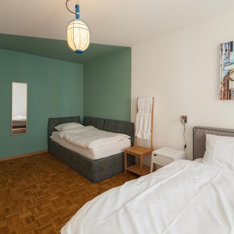 Postel nebo postele na pokoji v ubytování B&B Louis-Favre 21