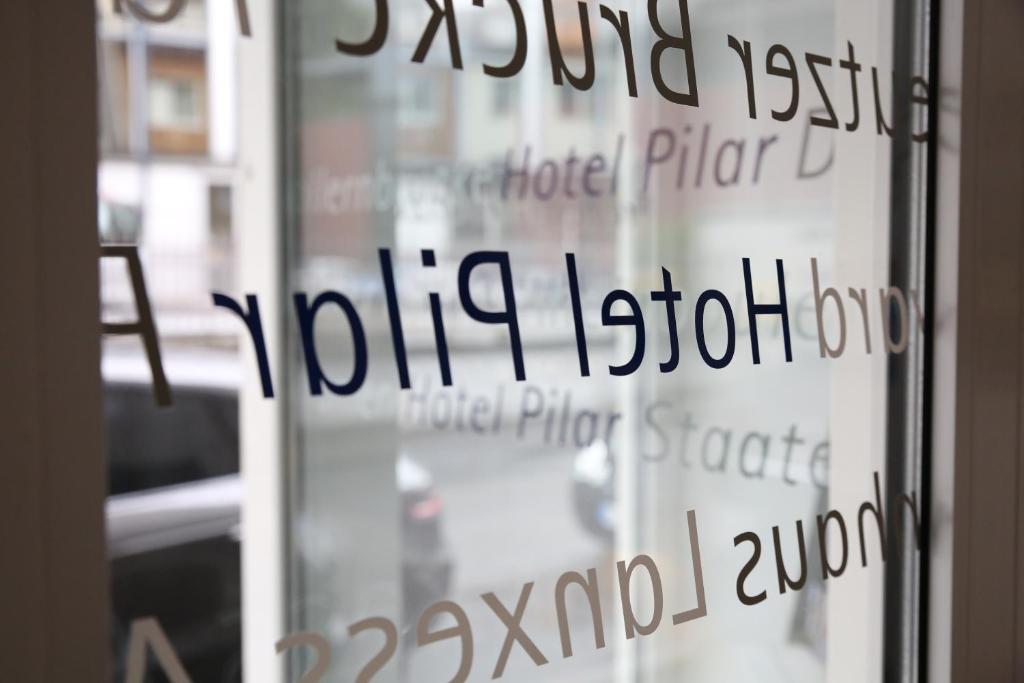 a glass door with the words vittoria estonian on it at Hotel Pilar Garni in Cologne