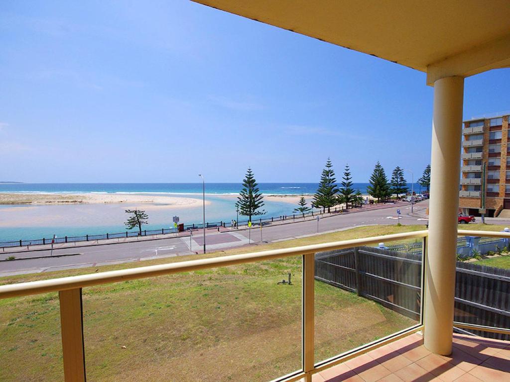 a balcony with a view of a beach and the ocean at Avilla Court 1 in The Entrance