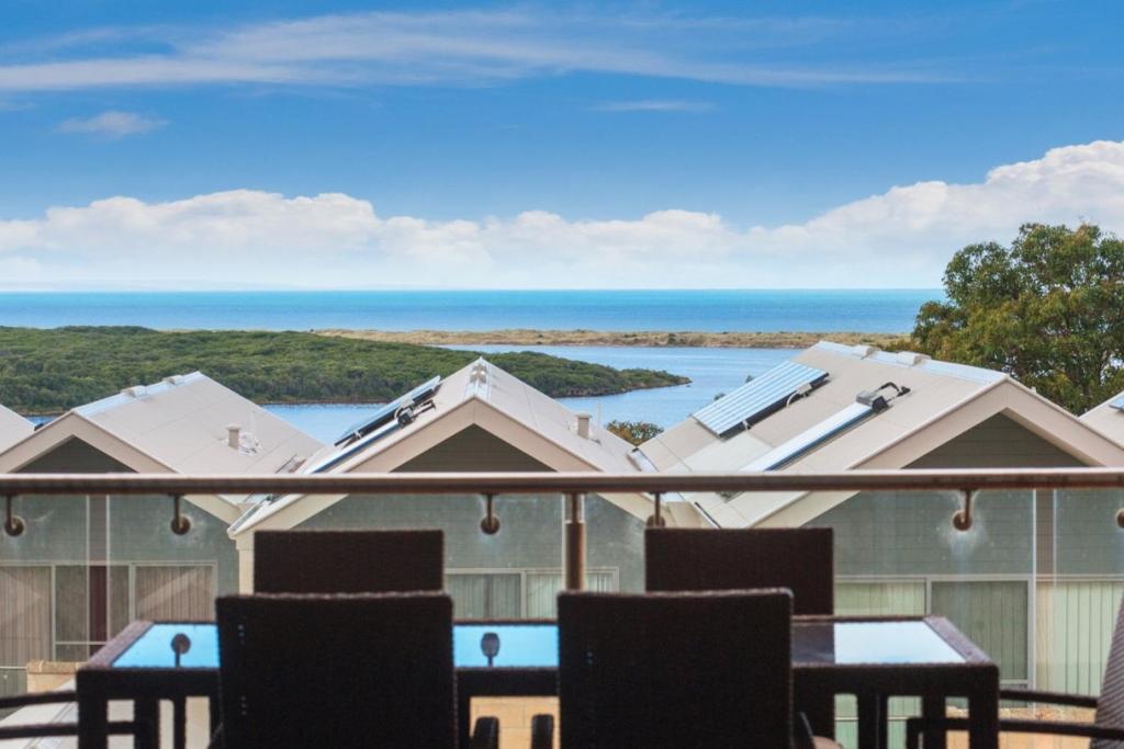 a balcony with chairs and a view of the ocean at 16 Seine Bay Apartment in Augusta