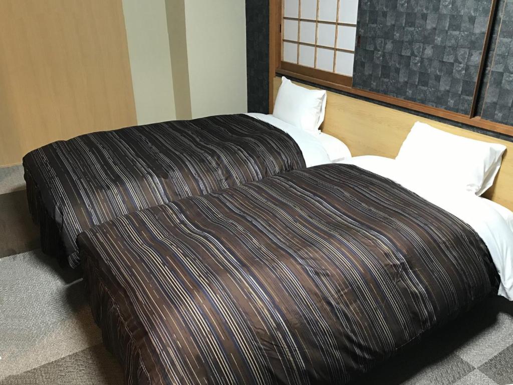 Postel nebo postele na pokoji v ubytování Ark Hotel Okayama -ROUTE INN HOTELS-