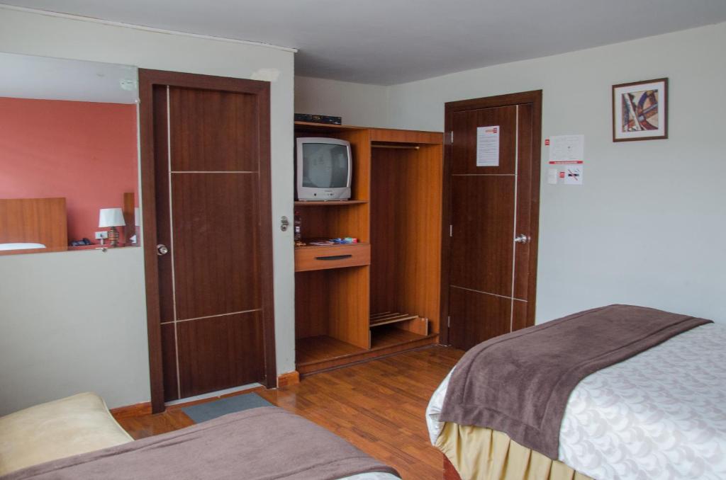 Postel nebo postele na pokoji v ubytování Hotel El Altar