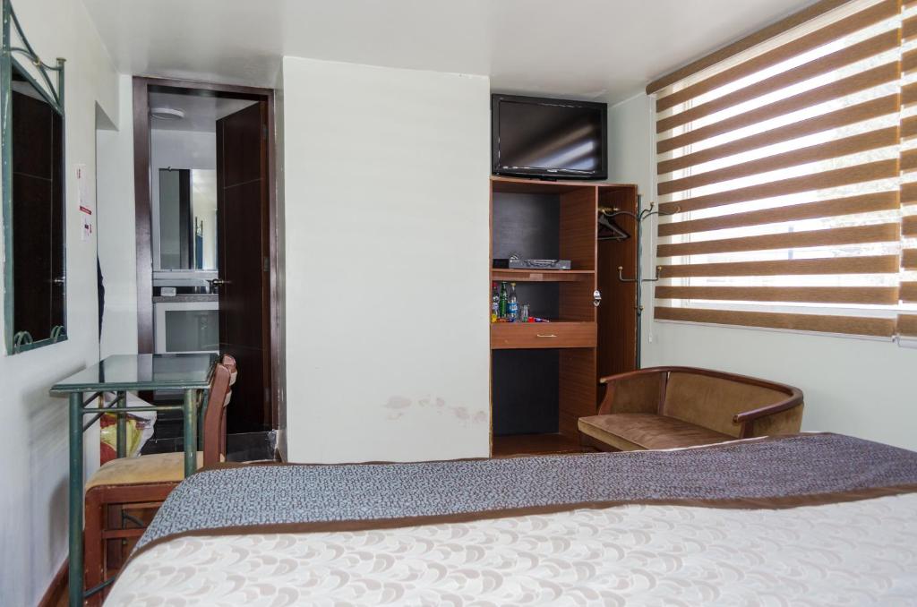 Postel nebo postele na pokoji v ubytování Hotel El Altar
