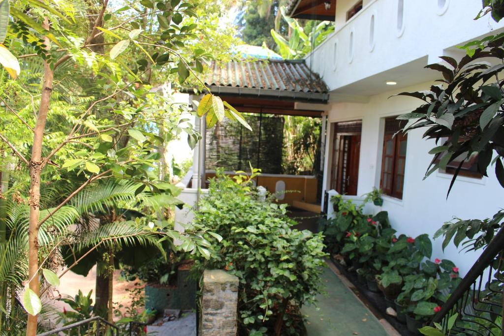 a house with a garden in front of it at Alex Home Stay in Kandy