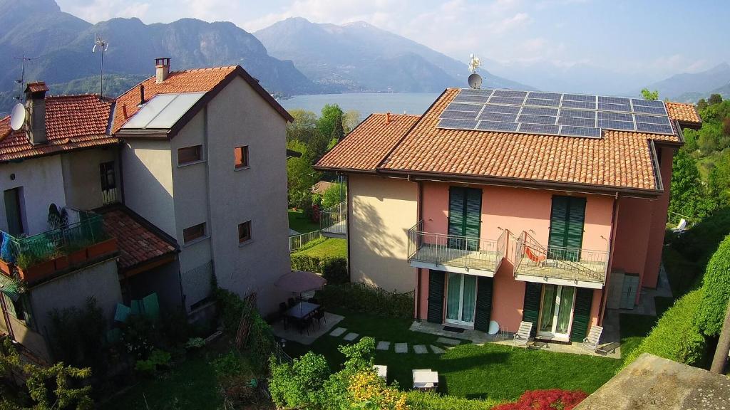 a house with a group of solar panels on its roof at Orchidea Apartment in Bellagio