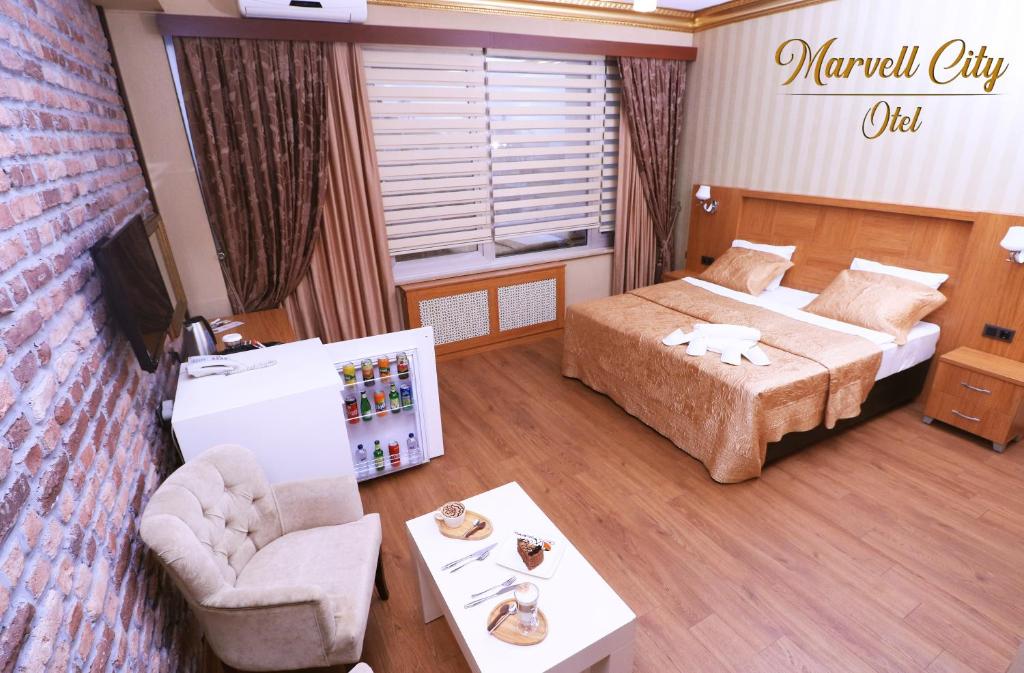 Postel nebo postele na pokoji v ubytování Marvell City Otel