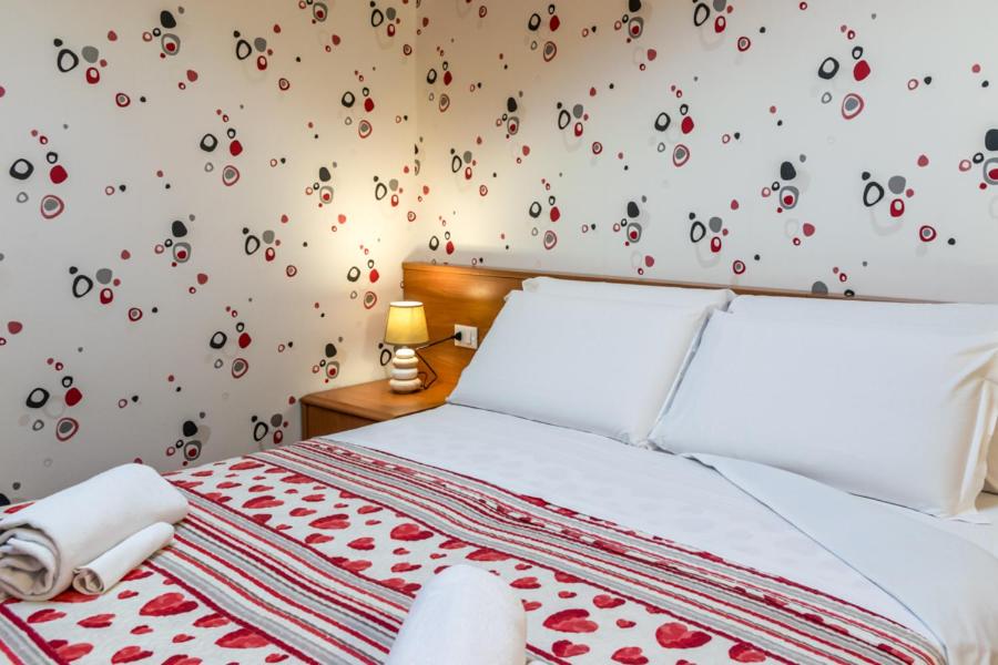 Postel nebo postele na pokoji v ubytování Hotel Donatello
