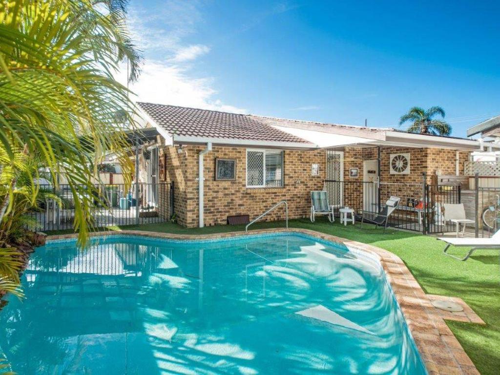 a swimming pool in front of a house at Manning Pool House in The Entrance