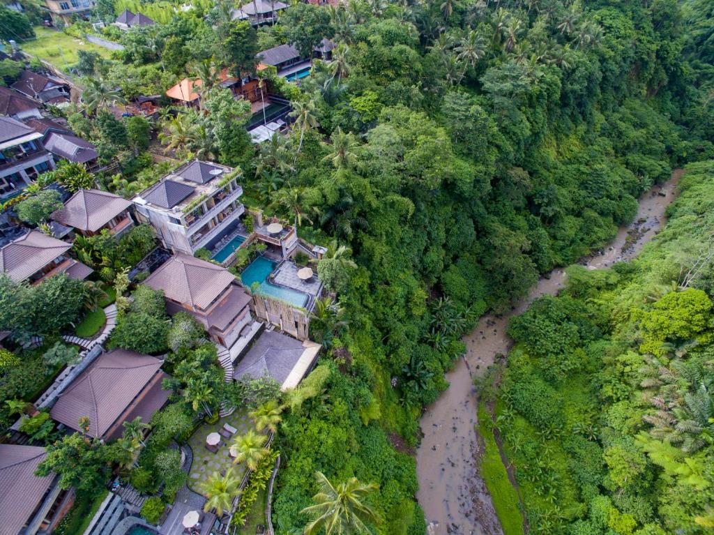 an aerial view of a resort with a river at Ubud Paras Villa in Ubud