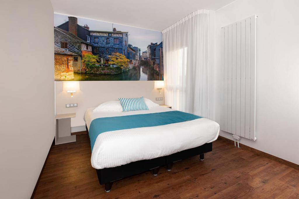 a bedroom with a bed and a painting on the wall at The Originals City, Hôtel Acadine, Pont-Audemer in Pont-Audemer