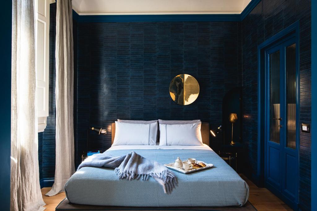 a bedroom with a bed with a plate of food on it at Florence Prestige Apartments ZANOBI 55 in Florence