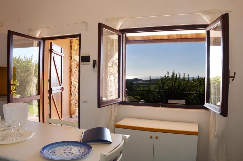 a kitchen with a table and a window with a view at CASE BELVEDERE in Chia