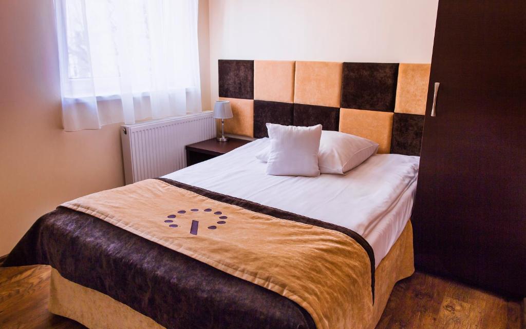 Postel nebo postele na pokoji v ubytování Boutique Hotel's III Piłsudskiego