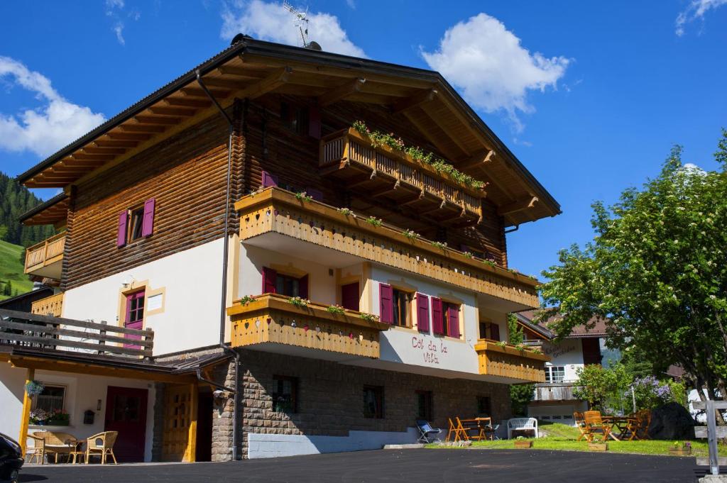 a building with balconies on the side of it at B&B Col Da La Vila in Canazei