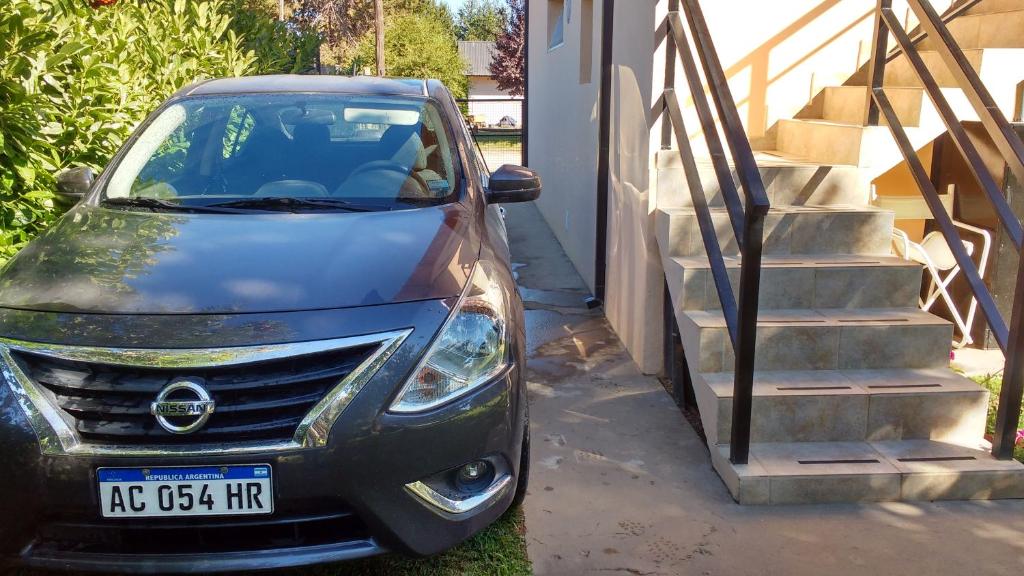 a car parked in front of a house with stairs at Montalto in Dina Huapi
