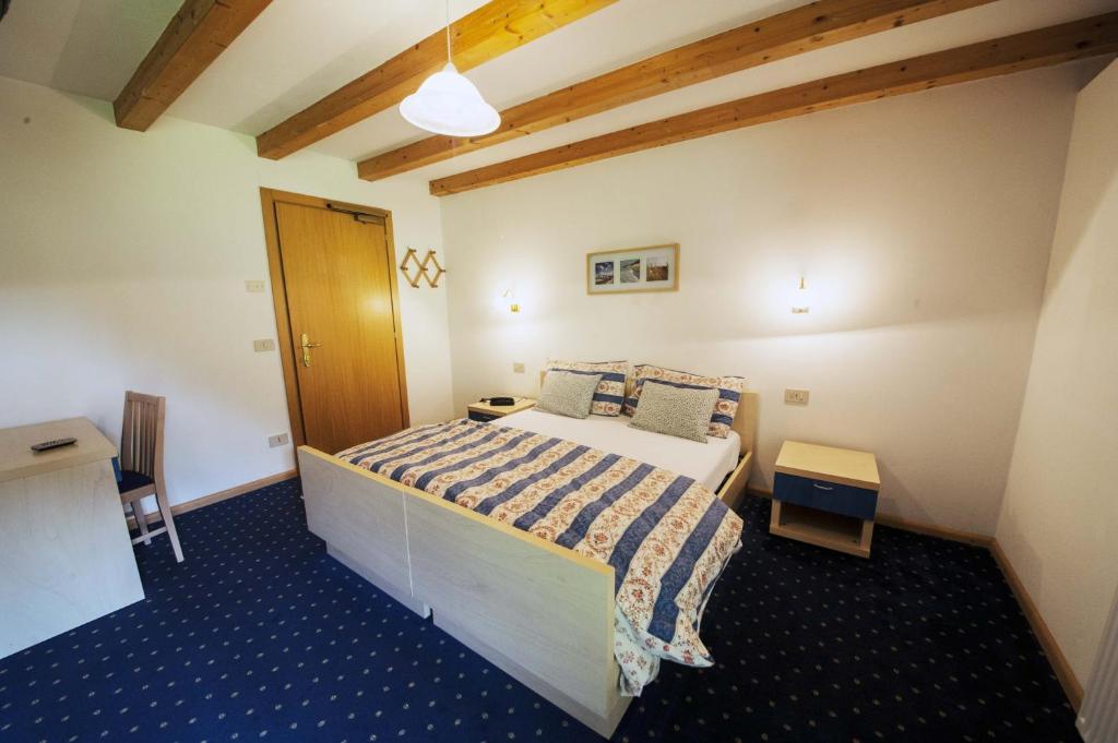 Łóżko lub łóżka w pokoju w obiekcie B&B Col Da La Vila