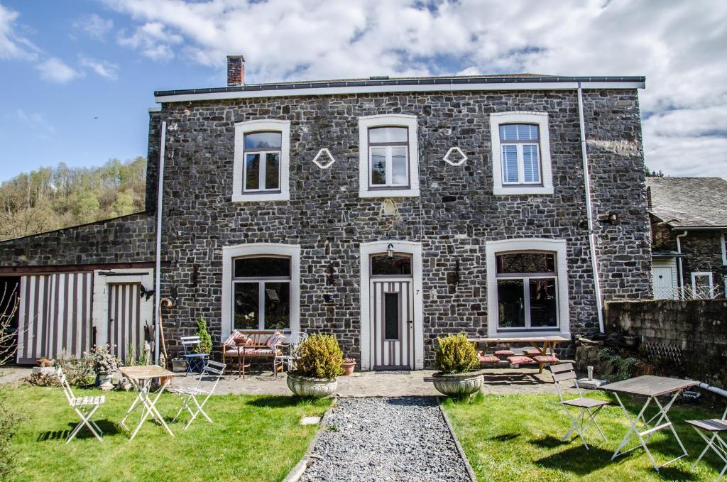 a brick house with a garden in front of it at B&B Au Canard in La-Roche-en-Ardenne