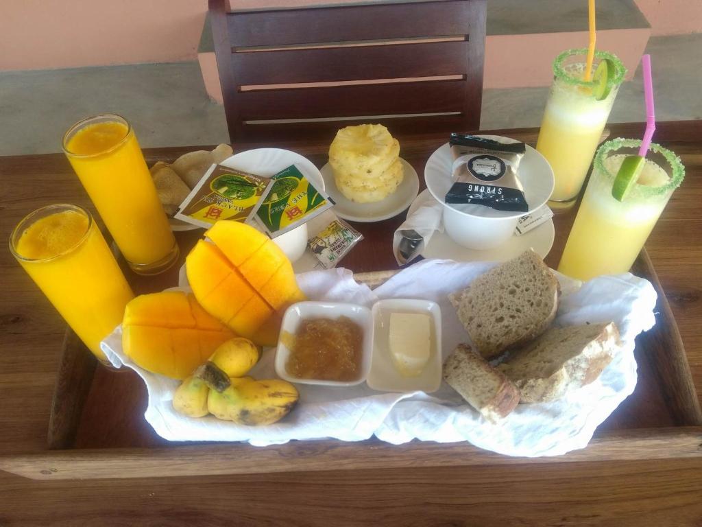 a tray of food with fruit and drinks on a table at LE TRANSAT in Ambatoloaka