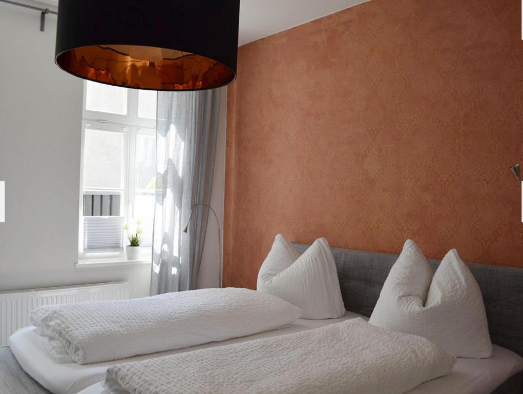 a bedroom with a couch with pillows and a window at Zum Jakobi 1 in Goslar