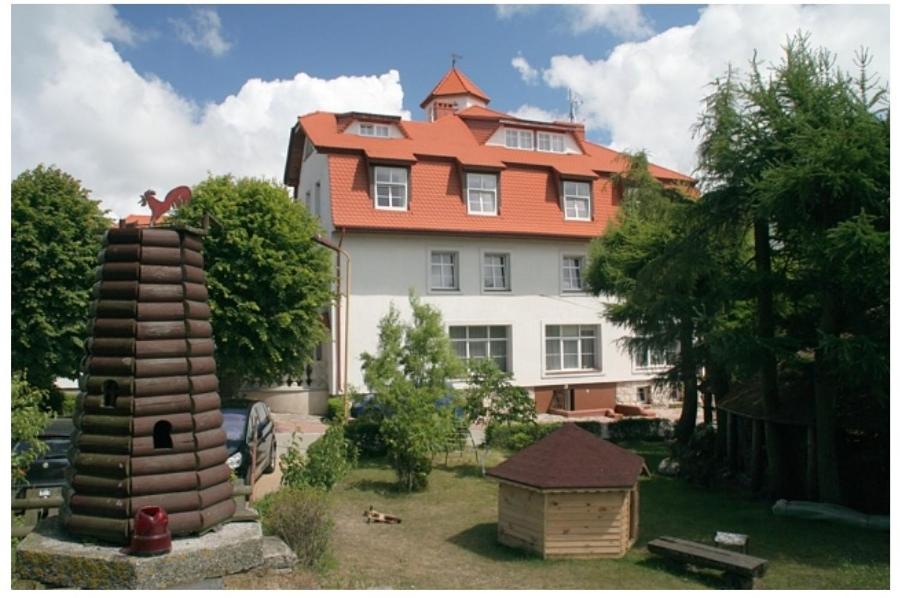 a large house with a bird house in front of it at Pokoje Gościnne Strażnica in Jarosławiec