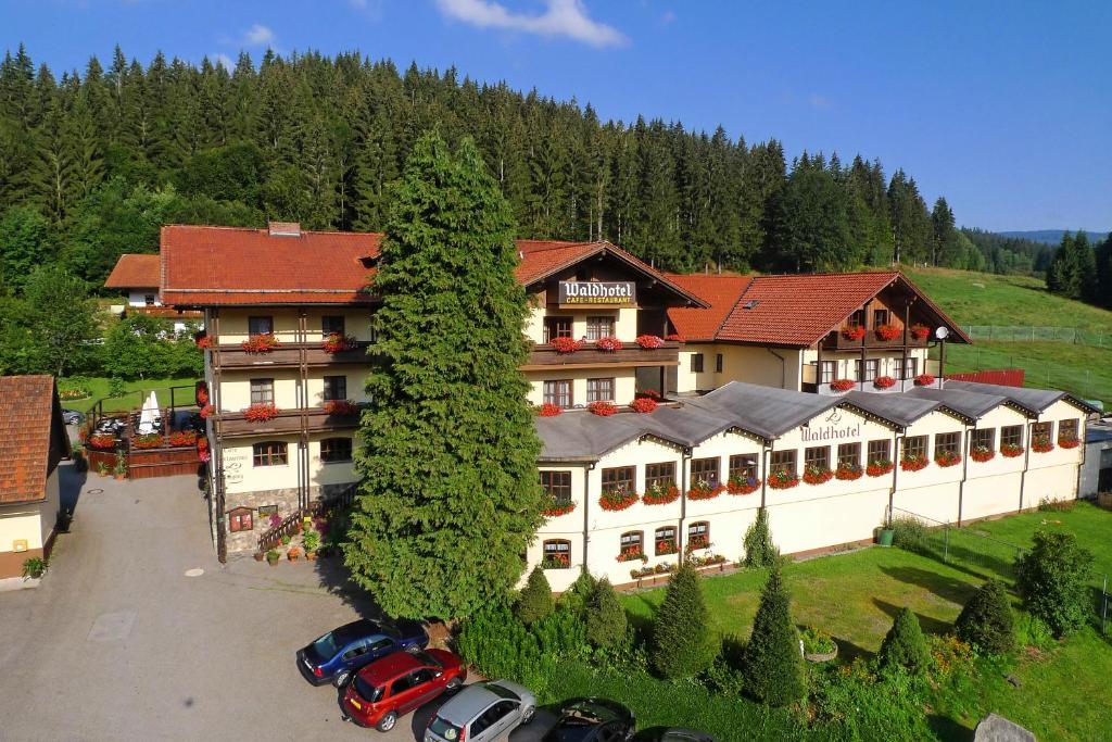 a large building with cars parked in front of it at Waldhotel Seebachschleife in Bayerisch Eisenstein