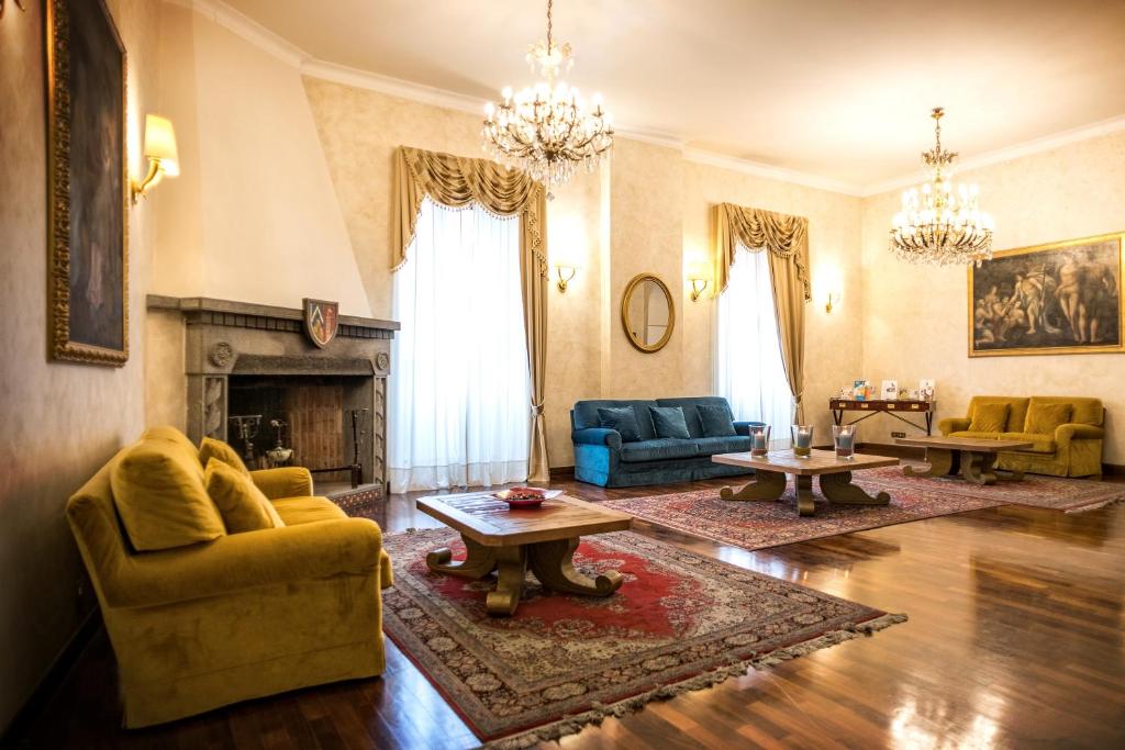 a living room with couches and a fireplace at Grand Hotel Italia in Orvieto