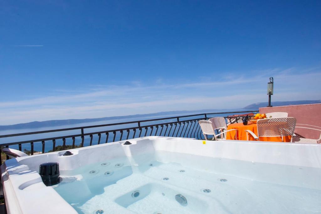 a jacuzzi tub sitting on top of a balcony at panoramic sea view house in Tučepi