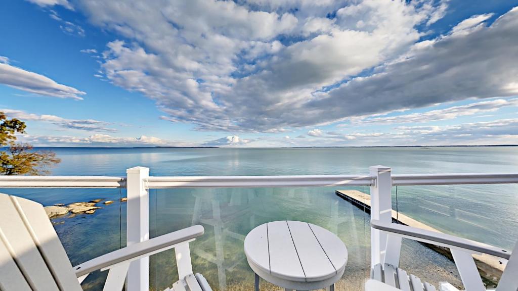 a balcony with a view of the ocean at Put-in-Bay Waterfront Condo #209 in Put-in-Bay