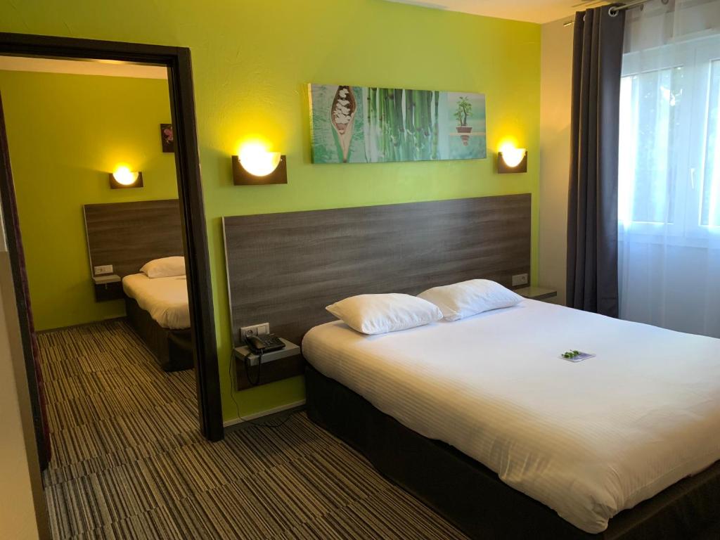 Postel nebo postele na pokoji v ubytování Hôtel Bagatelle