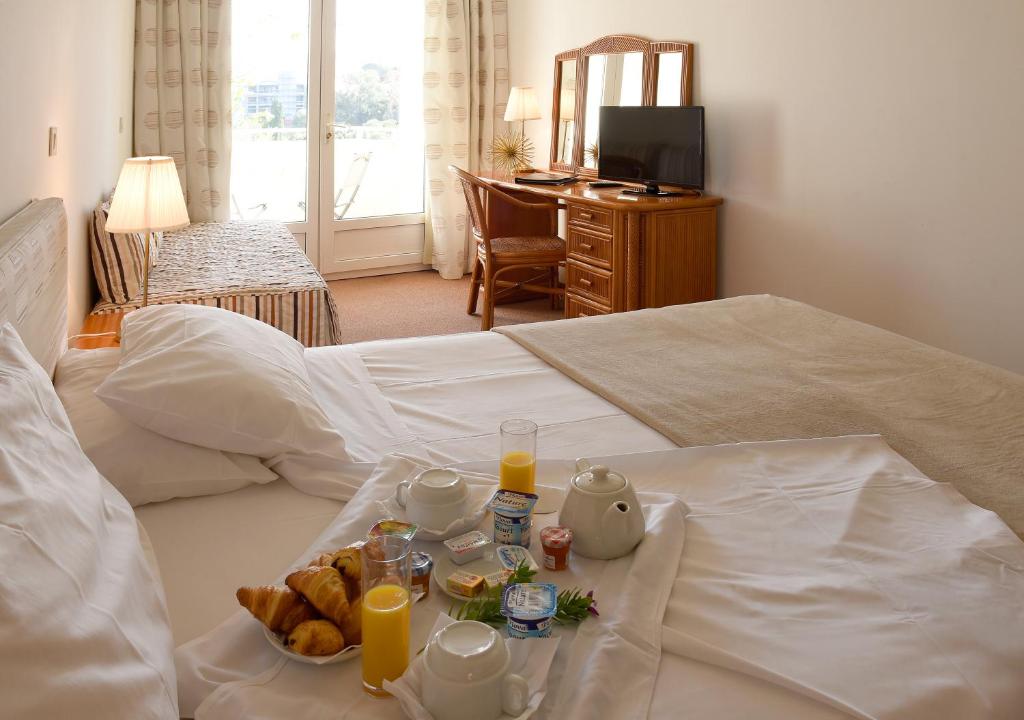 Postel nebo postele na pokoji v ubytování Hotel Le Tilbury
