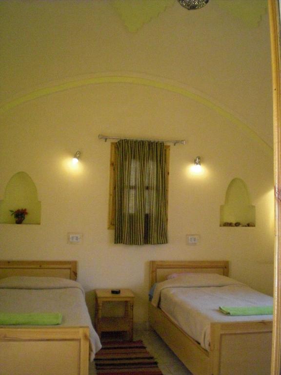 Postel nebo postele na pokoji v ubytování El Fayrouz Hotel