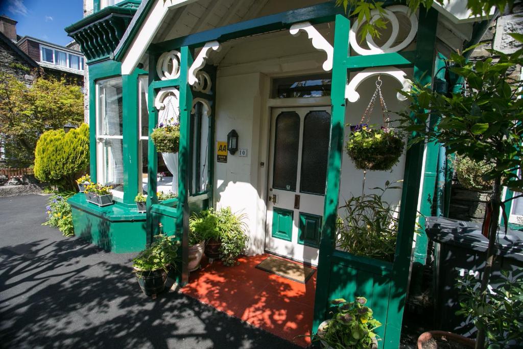 an open door of a house with potted plants at The Haven in Windermere