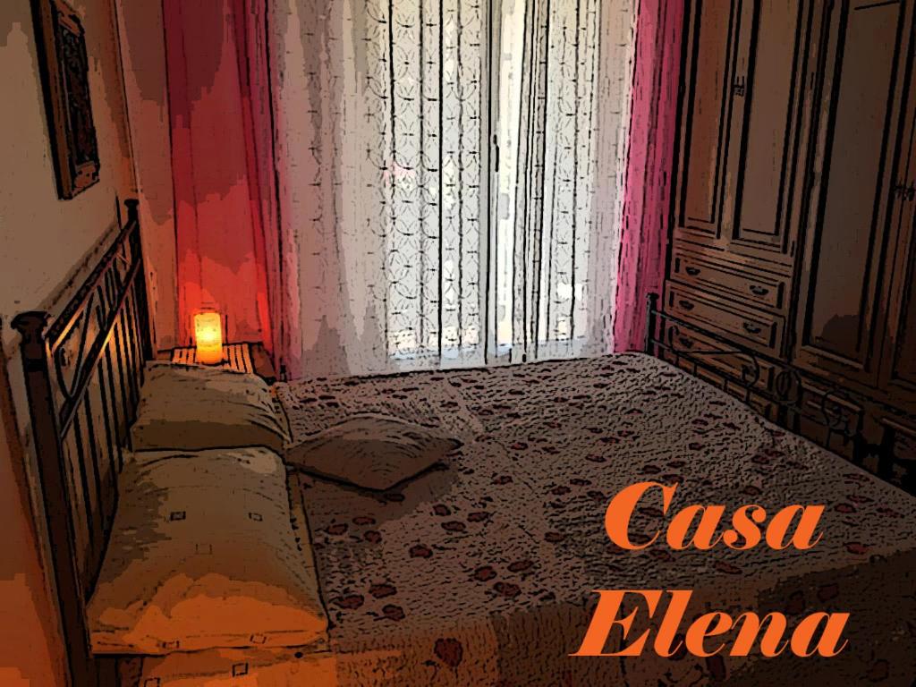 a room with a bed and a door with a candle at Casa Elena in Albisola Superiore